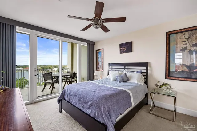 a bedroom with a large bed and a large window