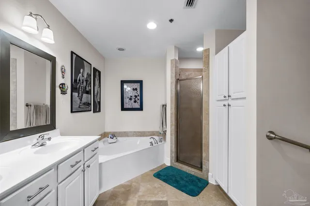 a bathroom with a tub a sink and mirror