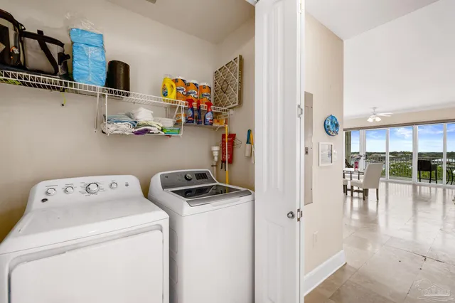 a view of storage and utility room with washer and dryer