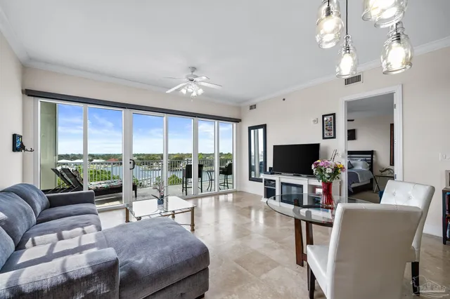 a living room with furniture a flat screen tv and a large window