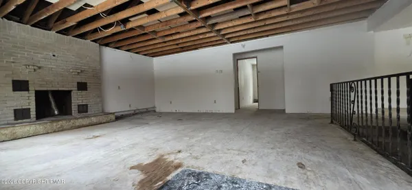 a view of a livingroom with fireplace and a window