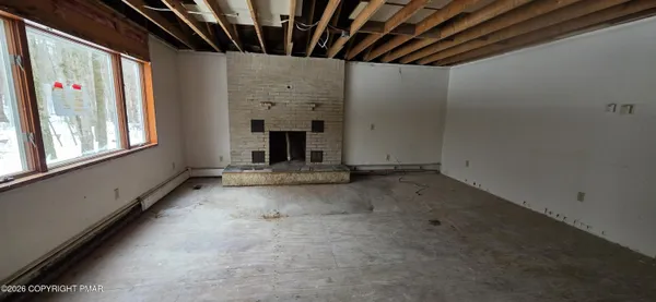 a view of an empty room with a fireplace
