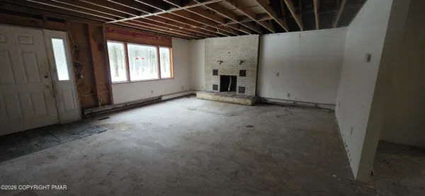 a view of empty room with a fireplace