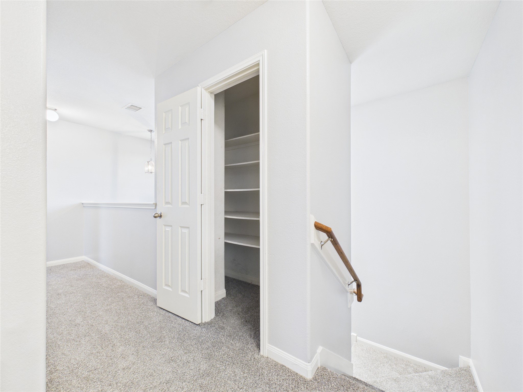 911 Marigold Road Baytown, TX 77521 - Photo 21 of 32 The spacious landing at the top of the stairs provides a welcoming transition to the upstairs bedroom areas.