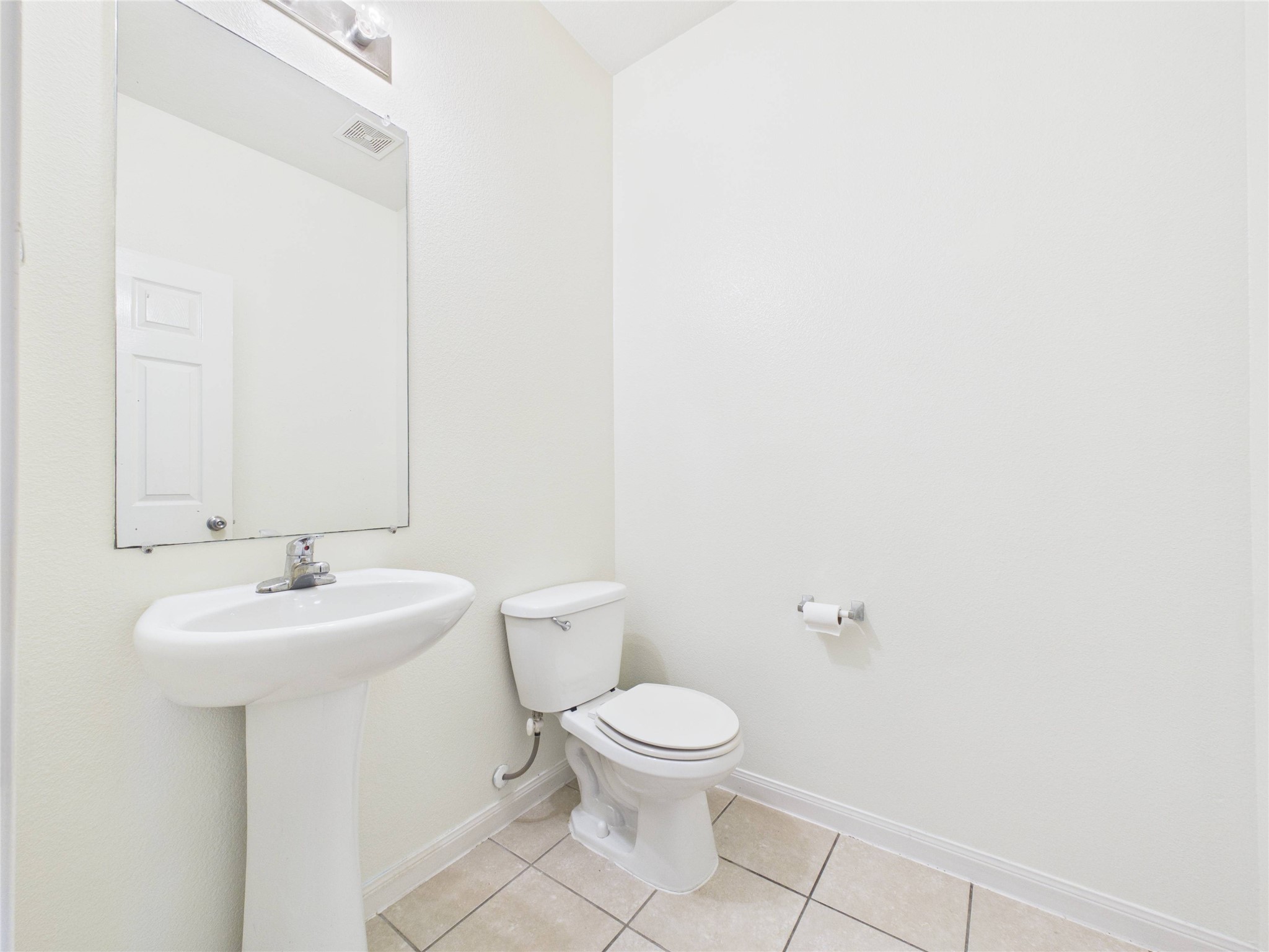911 Marigold Road Baytown, TX 77521 - Photo 4 of 32 This is the half bathroom downstairs. It's bright, clean, and simple.