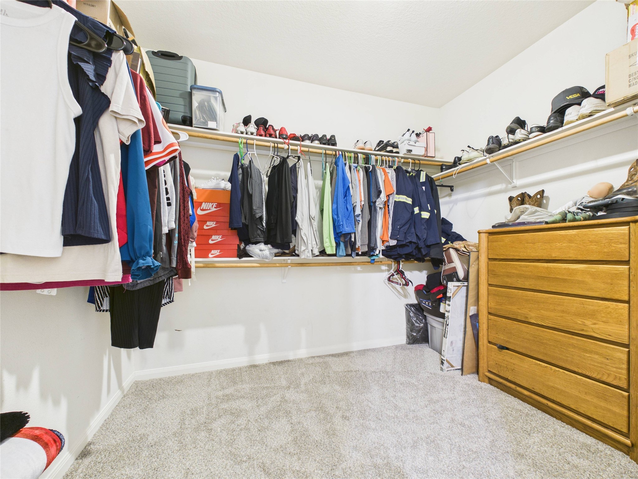 911 Marigold Road Baytown, TX 77521 - Photo 8 of 32 The primary bedroom features a spacious walk-in closet with carpeted flooring and ample hanging space. This closet has amply storage.