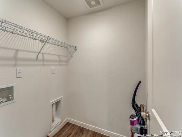 a view of storage and utility room with racks on the wall