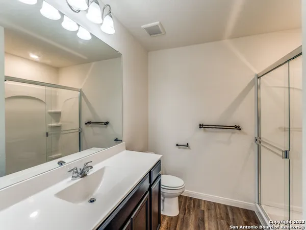 a bathroom with a sink a toilet and a mirror