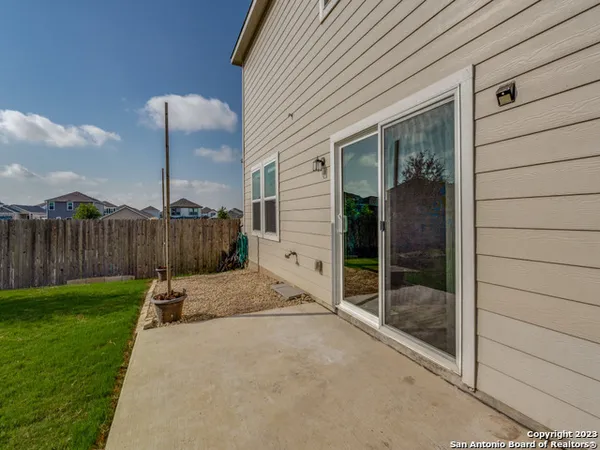 a view of backyard with wooden fence