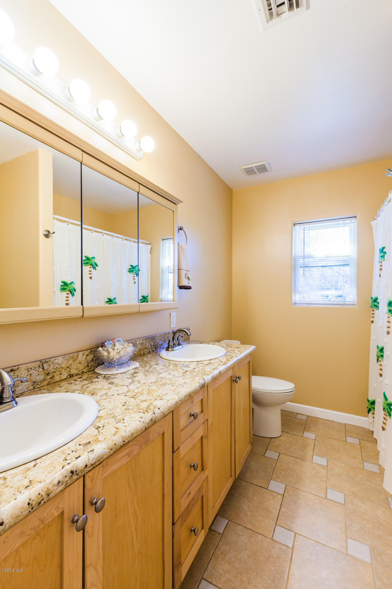 6304 Alta Vista Road Simi Valley, CA 93063 - Photo 8 of 20 a bathroom with a granite countertop sink a toilet and a mirror