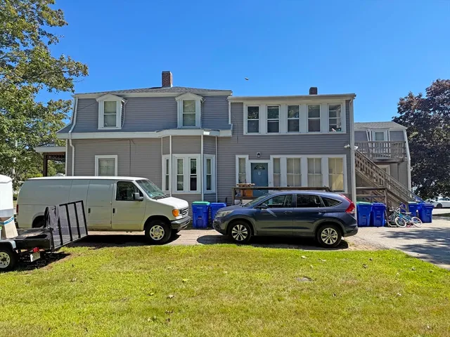 a view of a house with backyard and sitting area