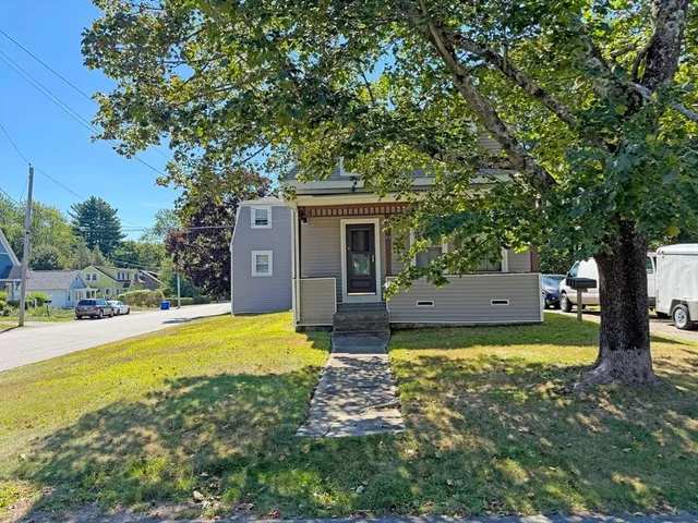 a kitchen with white cabinets and sink