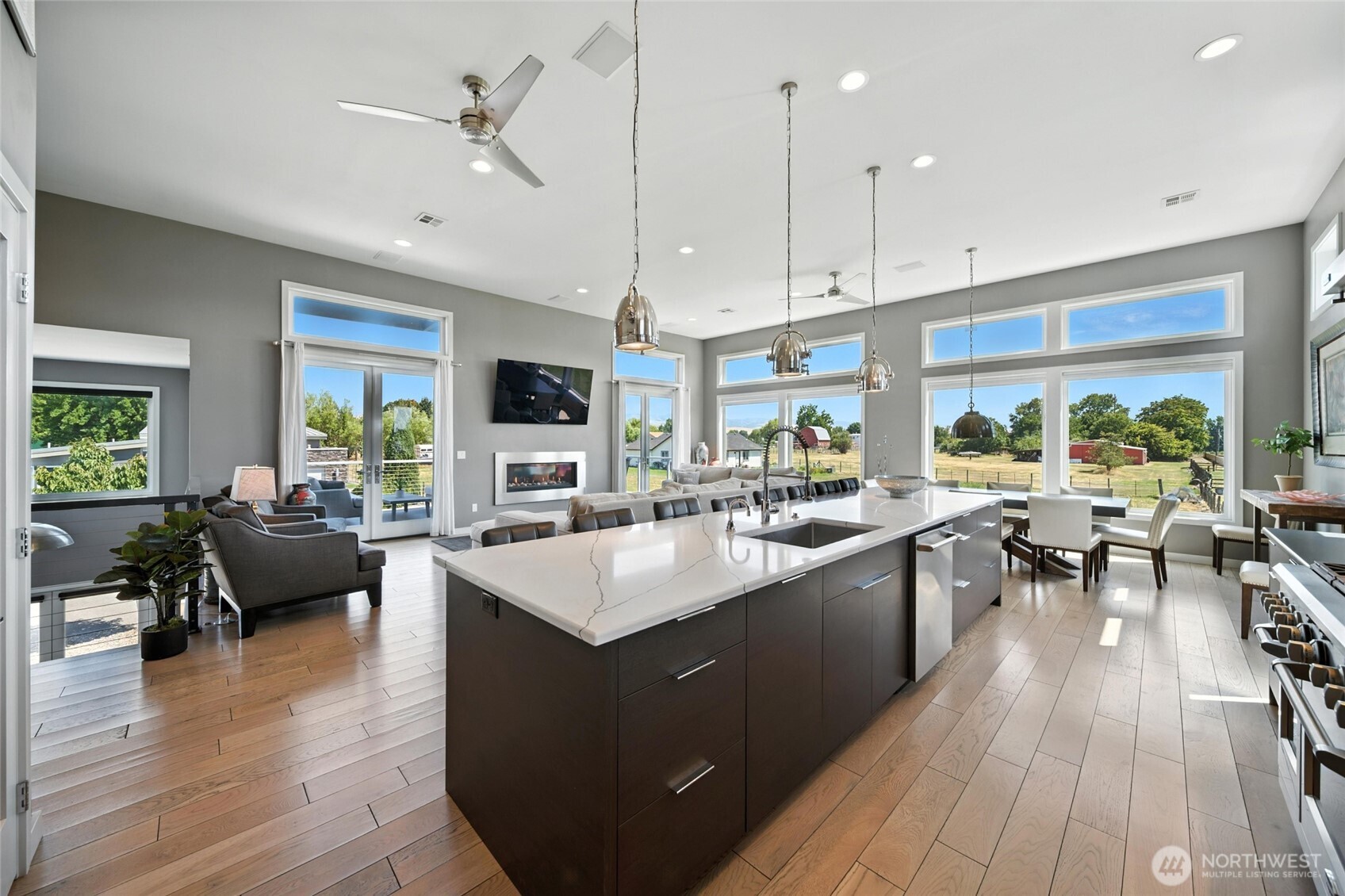 2150 Paramount Street Walla Walla, WA 99362 - Photo 4 of 40 a living room with stainless steel appliances kitchen island granite countertop a large kitchen island a stove a sink a dining table and chairs with wooden floor
