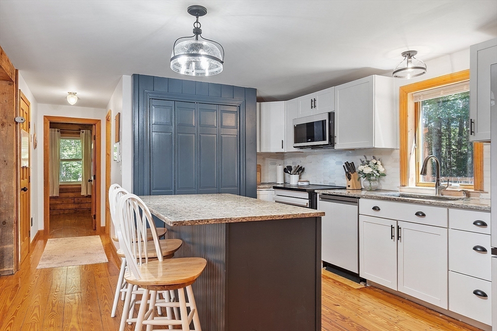 173 Minott Road Westminster, MA 01473 - Photo 3 of 33 a kitchen with a table chairs sink and cabinets