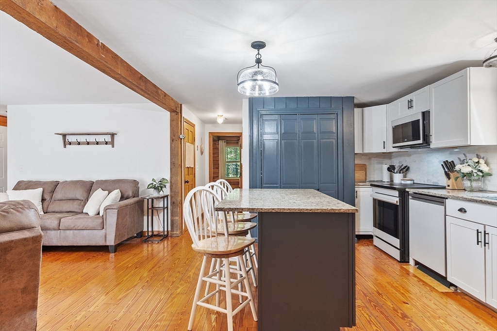 173 Minott Road Westminster, MA 01473 - Photo 6 of 33 a living room with stainless steel appliances granite countertop furniture a fireplace a rug and a window