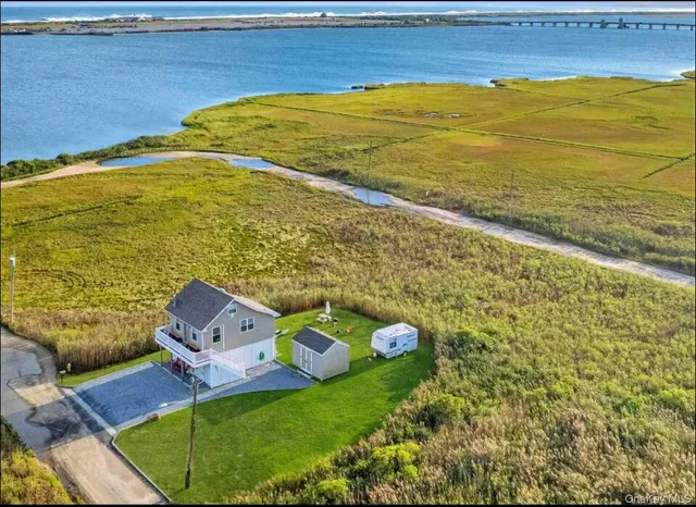 a bed sitting in a room next to a blue wall