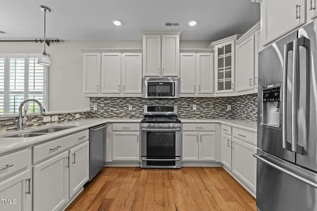 a kitchen with a sink stove and refrigerator