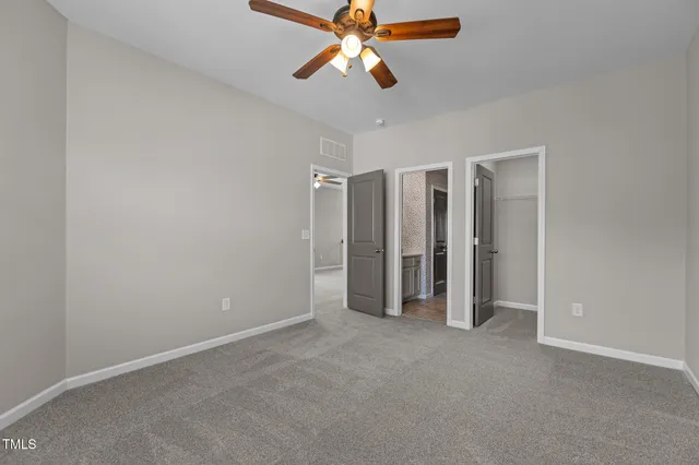 a view of empty room with ceiling fan