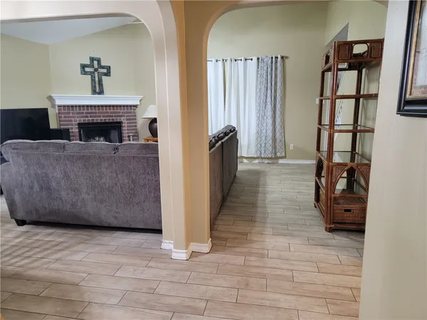 a living room with furniture and a fireplace
