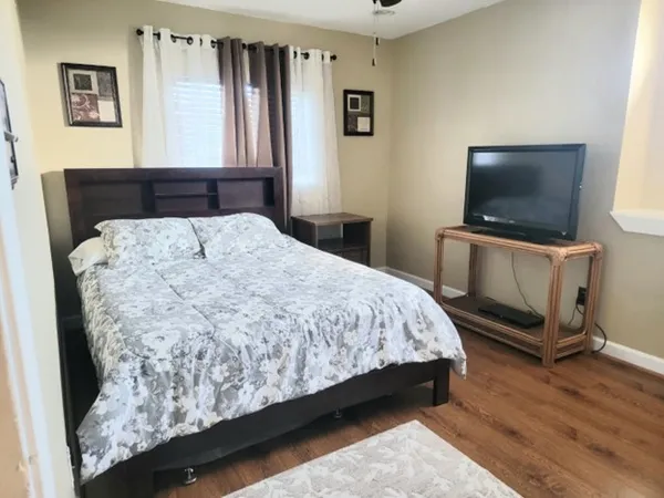 a bedroom with a bed and a flat screen tv