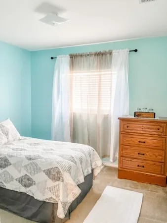 a bedroom with a bed and a mirror