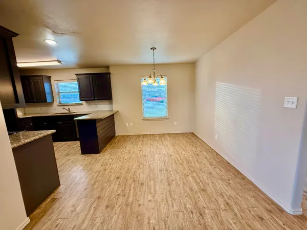 a workspace with wooden floor and window