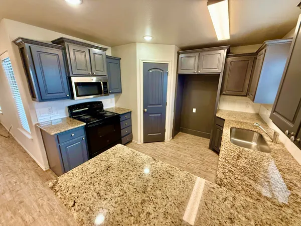 a kitchen with a refrigerator stove and sink