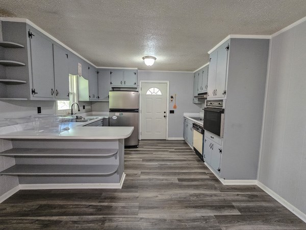 265 Tyler Road Ellijay, GA 30540 - Photo 26 of 43 a kitchen with stainless steel appliances granite countertop a stove refrigerator and cabinets