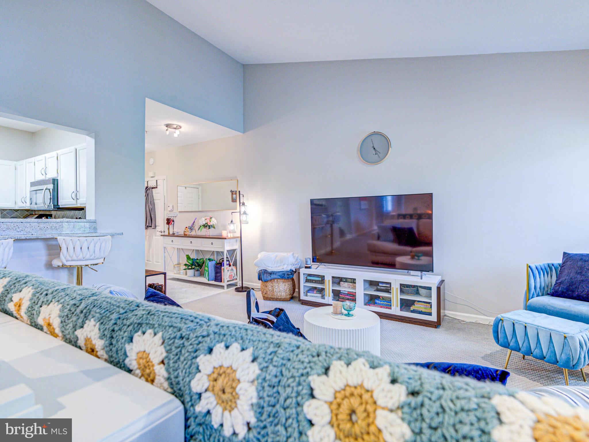 1720 Lake Shore Crest Drive, Unit 35 Reston, VA 20190 - Photo 11 of 41 a living room with furniture and a flat screen tv