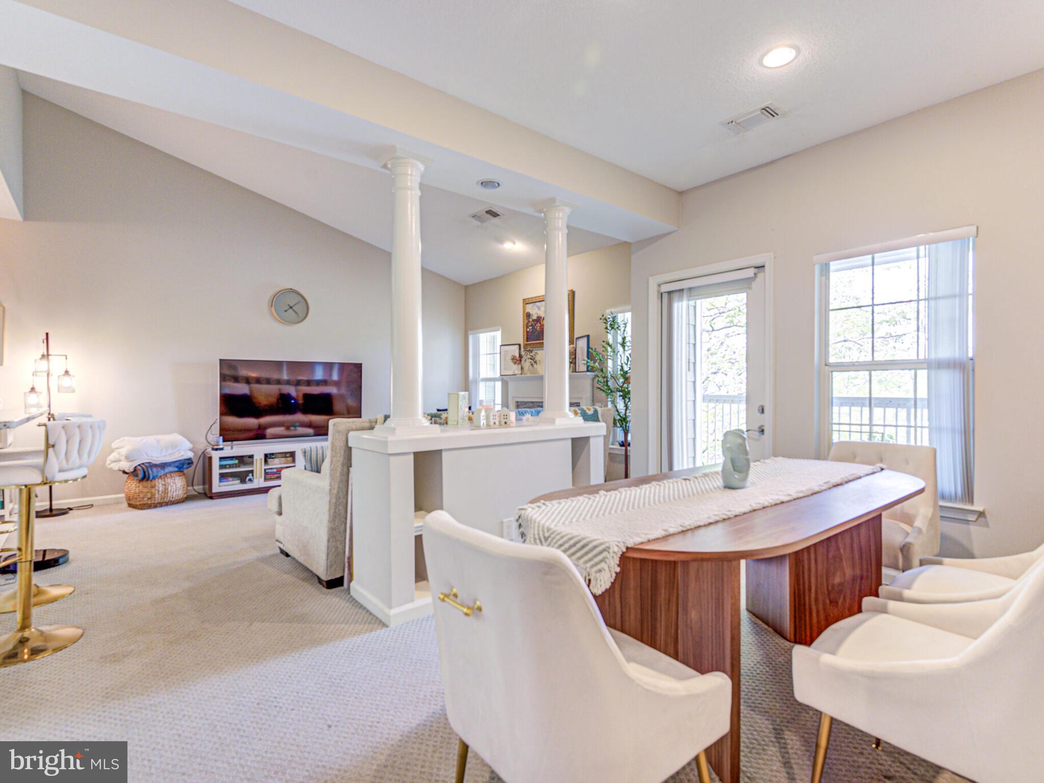 1720 Lake Shore Crest Drive, Unit 35 Reston, VA 20190 - Photo 13 of 41 a open dining room with stainless steel appliances kitchen island granite countertop a dining table chairs and a refrigerator