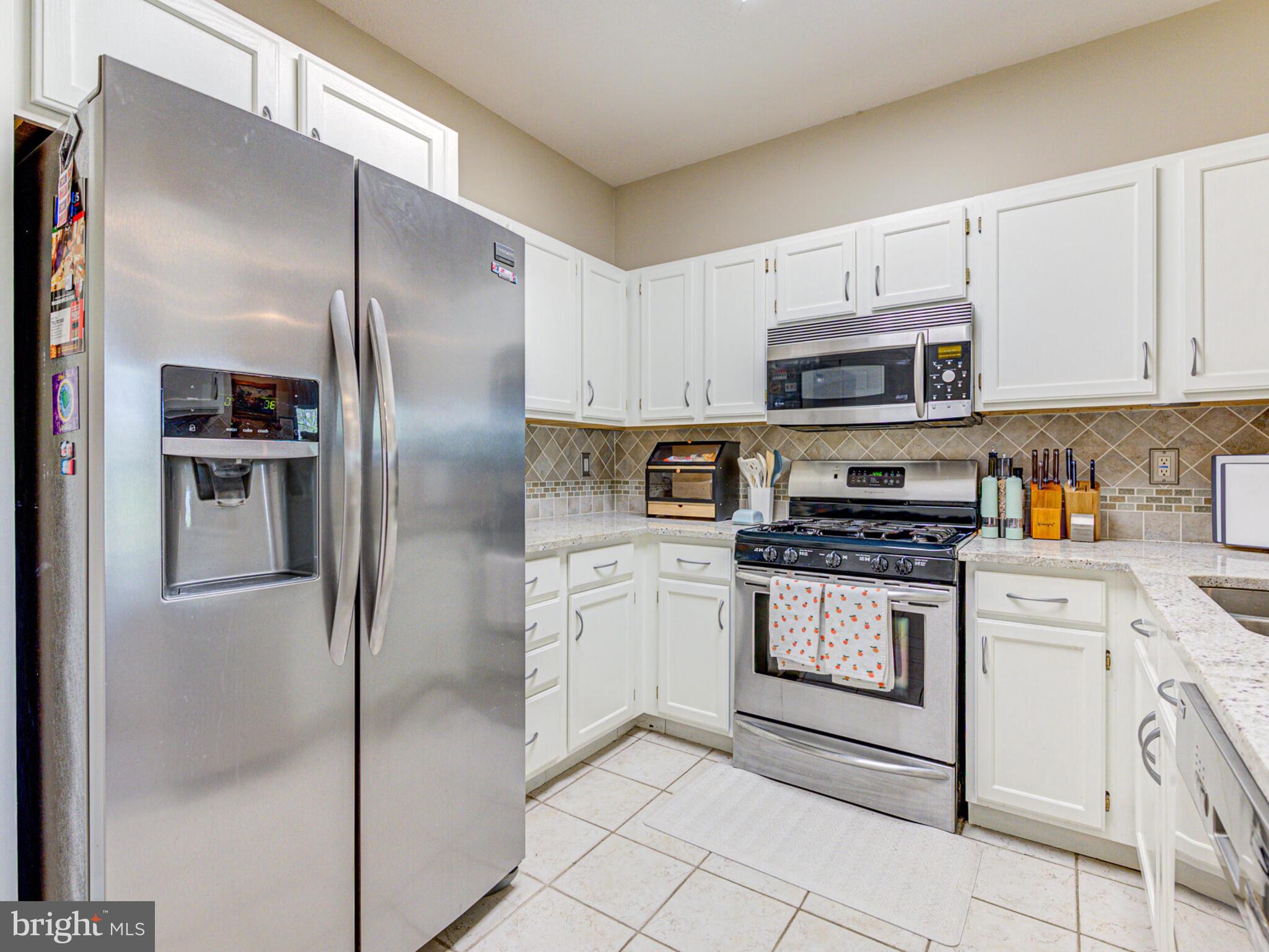 1720 Lake Shore Crest Drive, Unit 35 Reston, VA 20190 - Photo 18 of 41 a kitchen with stainless steel appliances cabinets a sink and a counter top space