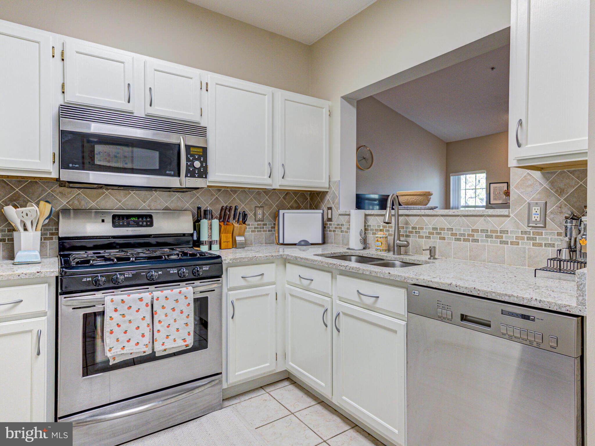 1720 Lake Shore Crest Drive, Unit 35 Reston, VA 20190 - Photo 20 of 41 a kitchen with stainless steel appliances granite countertop a stove and cabinets