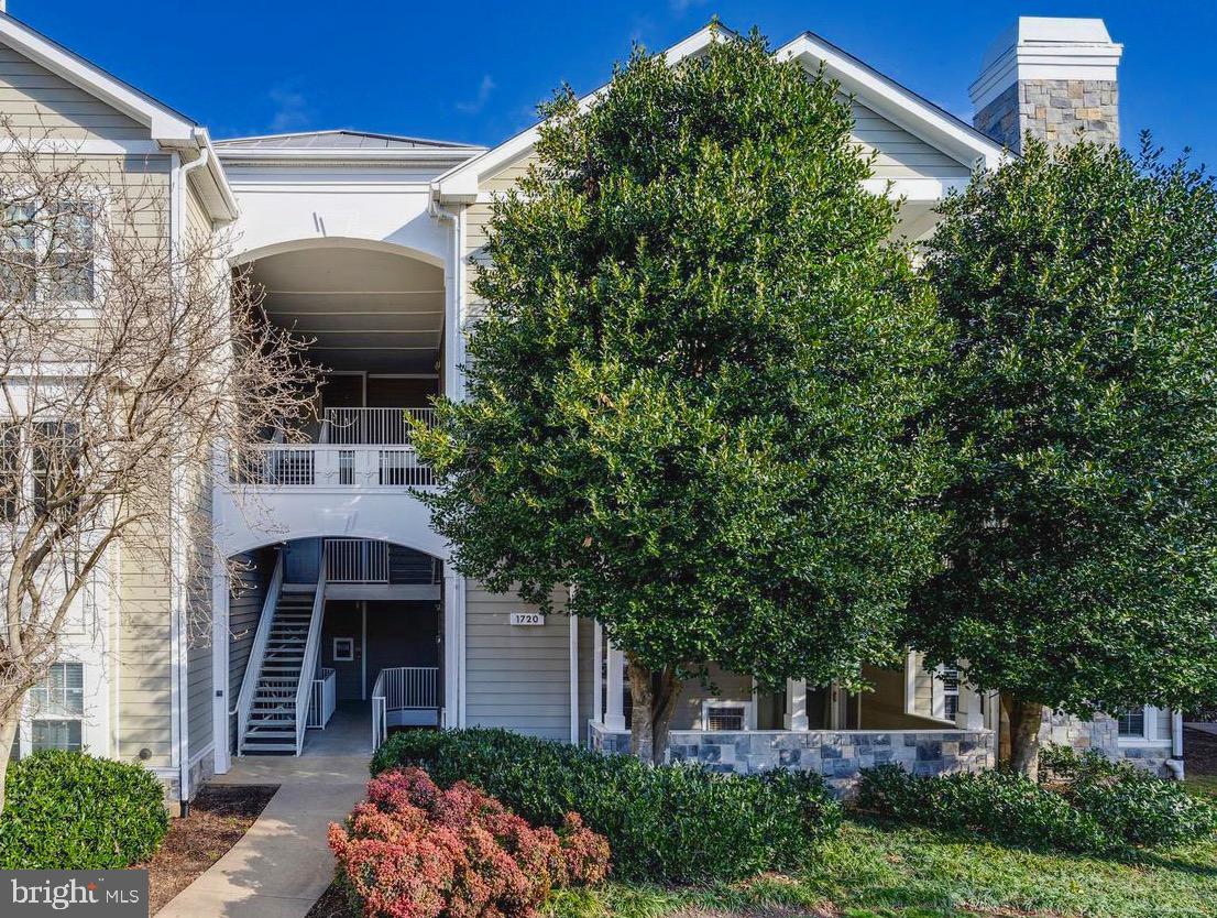 1720 Lake Shore Crest Drive, Unit 35 Reston, VA 20190 - Photo 2 of 41 a front view of a house with garden