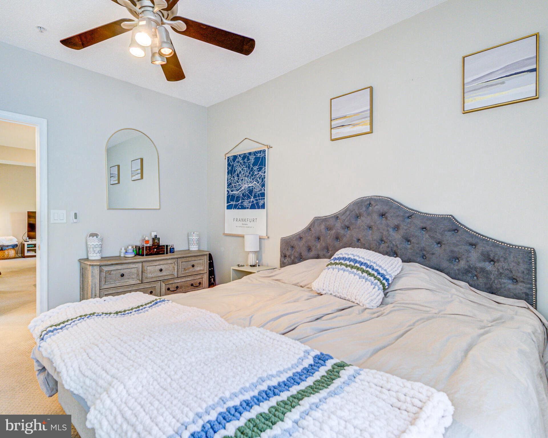1720 Lake Shore Crest Drive, Unit 35 Reston, VA 20190 - Photo 24 of 41 a bedroom with a bed and a chandelier