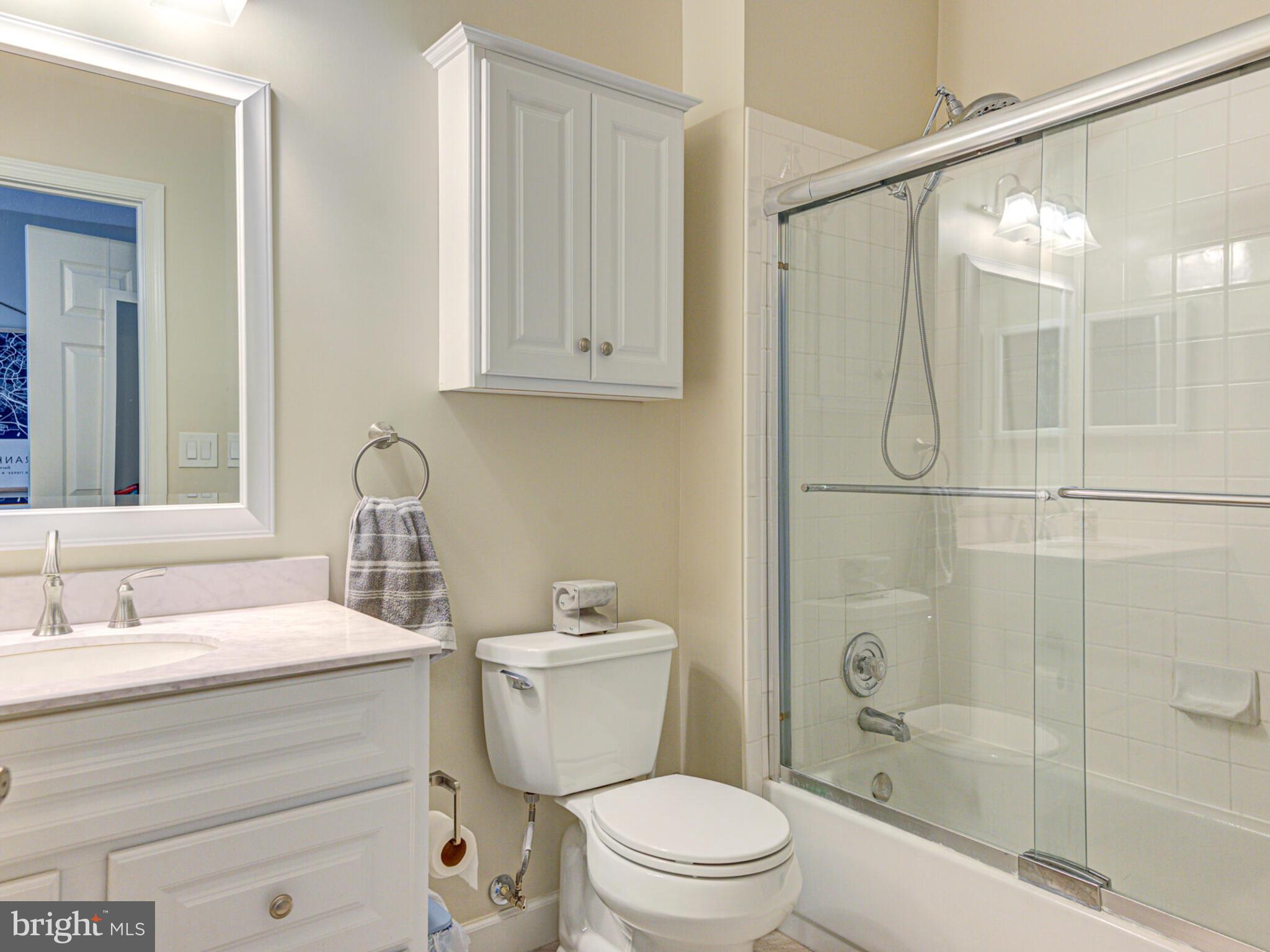 1720 Lake Shore Crest Drive, Unit 35 Reston, VA 20190 - Photo 27 of 41 a bathroom with a sink toilet and shower