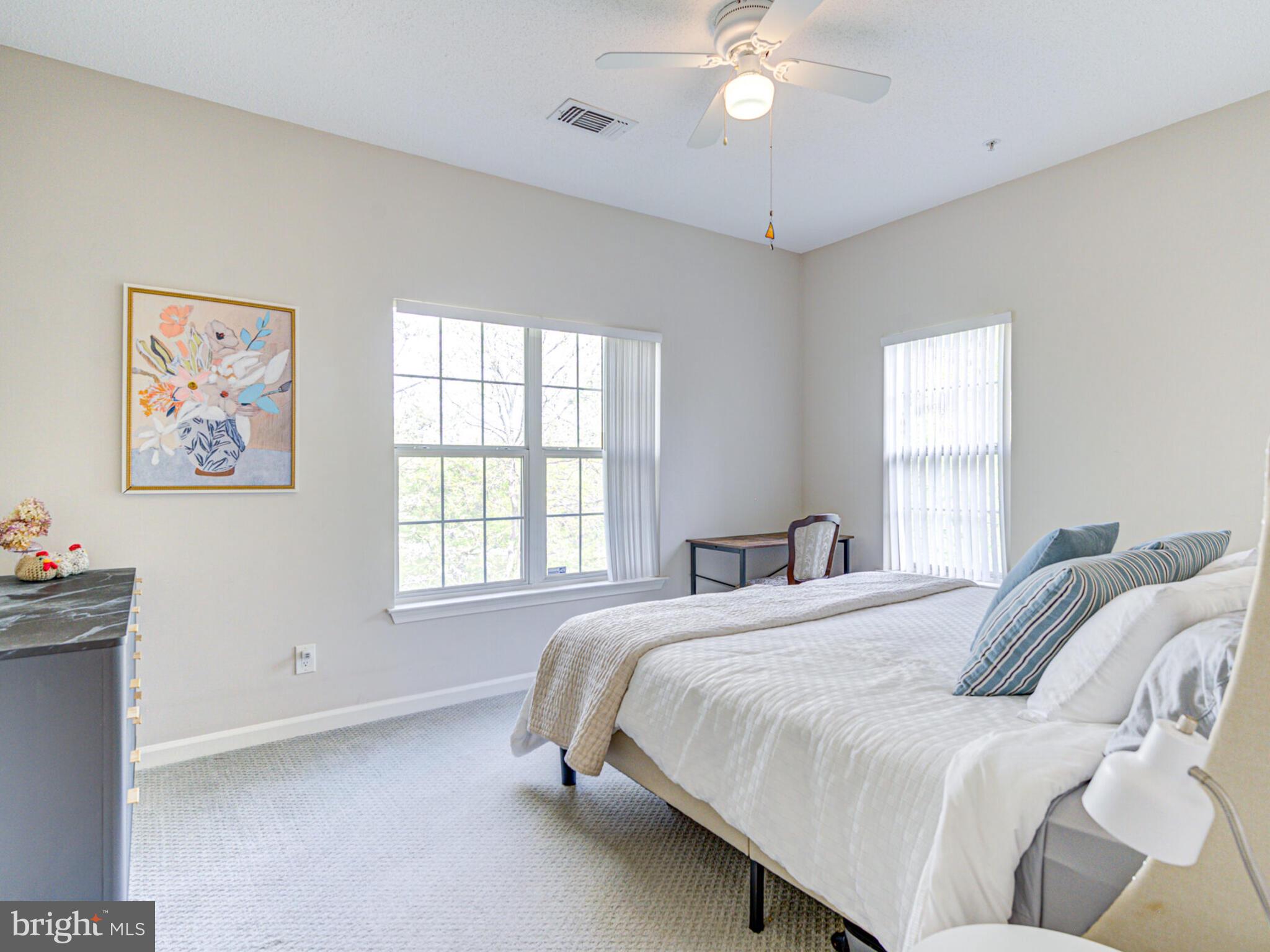 1720 Lake Shore Crest Drive, Unit 35 Reston, VA 20190 - Photo 29 of 41 a bed room with a bed and a chandelier