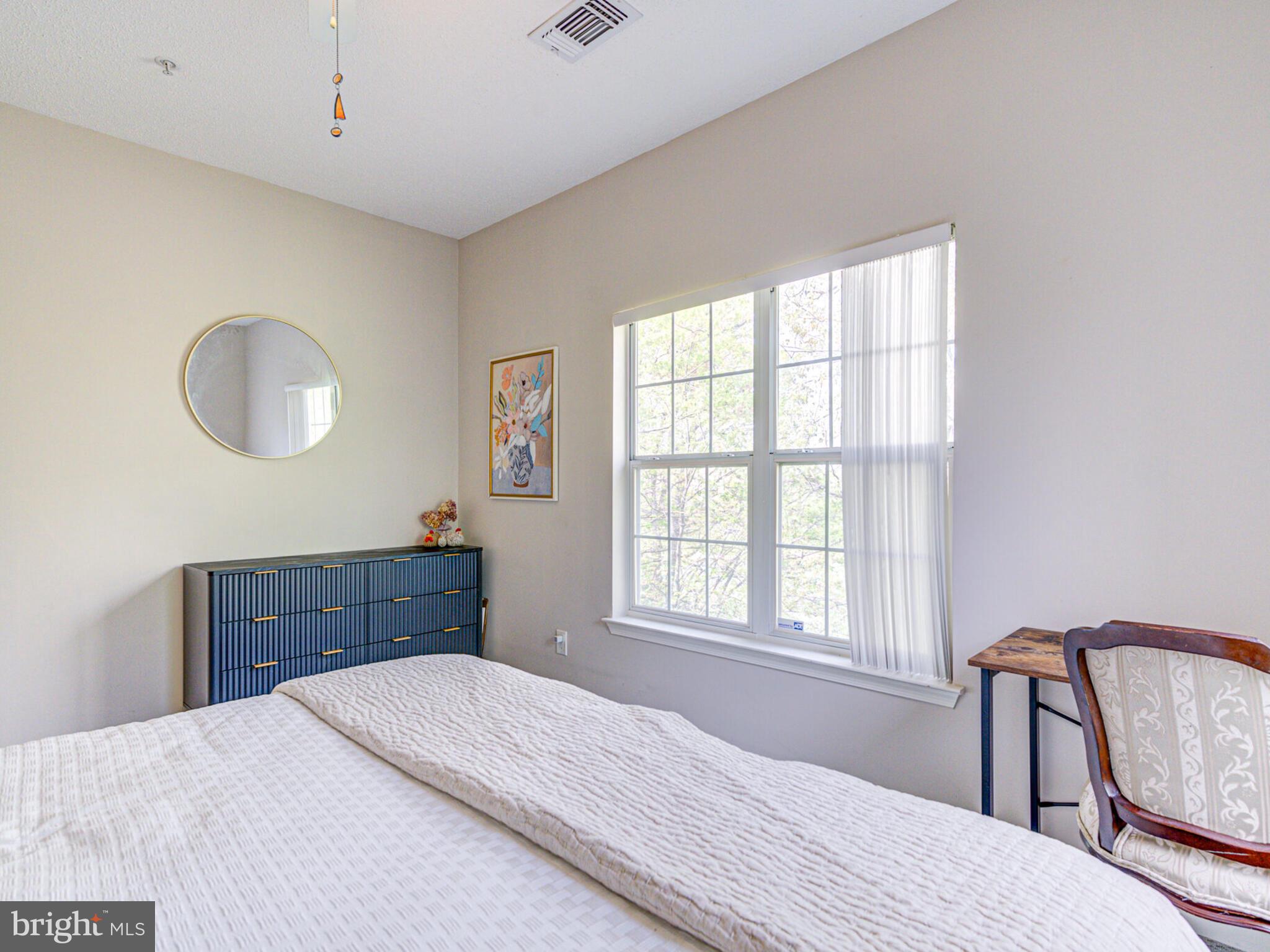 1720 Lake Shore Crest Drive, Unit 35 Reston, VA 20190 - Photo 31 of 41 a bedroom with a bed and a window