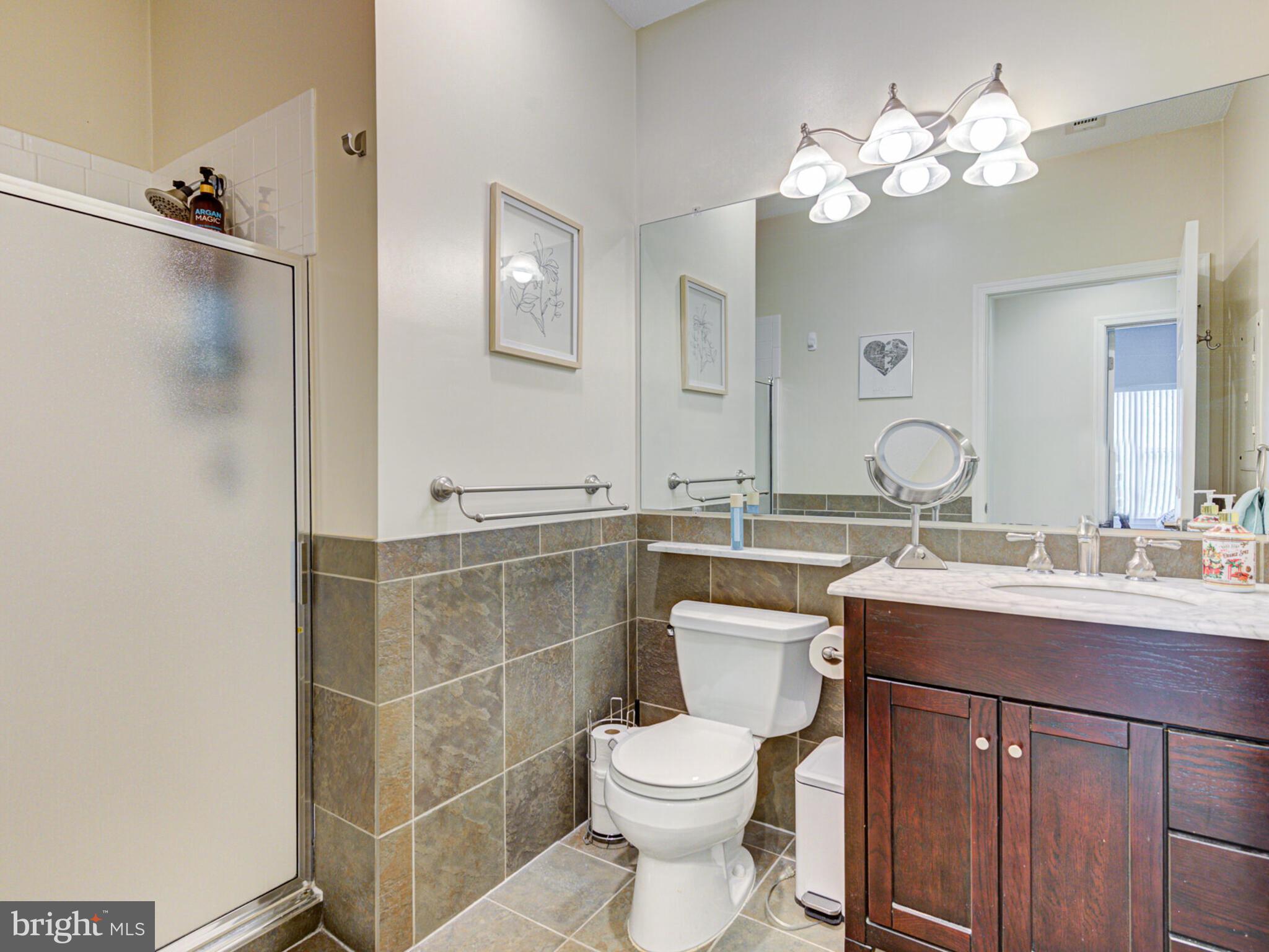 1720 Lake Shore Crest Drive, Unit 35 Reston, VA 20190 - Photo 34 of 41 a bathroom with a toilet sink and mirror