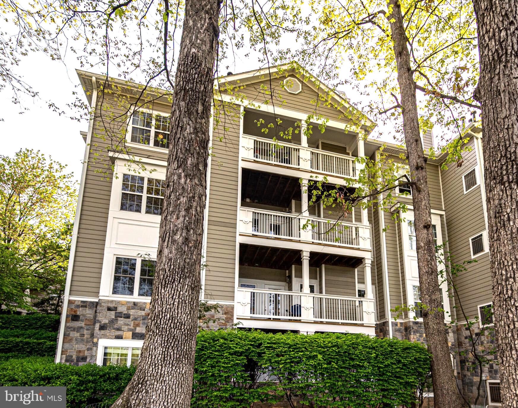 1720 Lake Shore Crest Drive, Unit 35 Reston, VA 20190 - Photo 40 of 41 a view of a brick building next to a yard