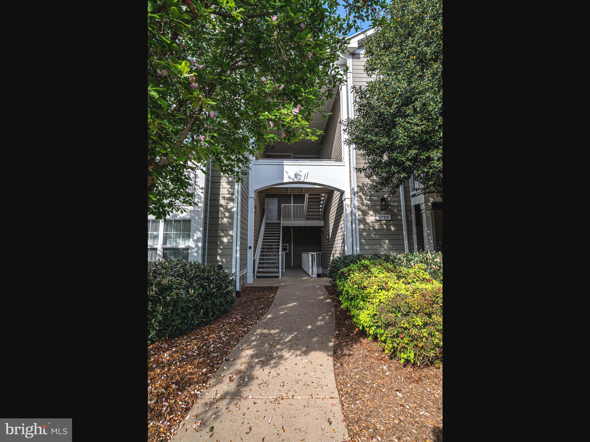 1720 Lake Shore Crest Drive, Unit 35 Reston, VA 20190 - Photo 4 of 41 a front view of a house with garden