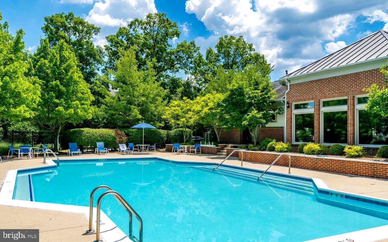 1720 Lake Shore Crest Drive, Unit 35 Reston, VA 20190 - Photo 41 of 41 a view of a swimming pool with lawn chairs and plants
