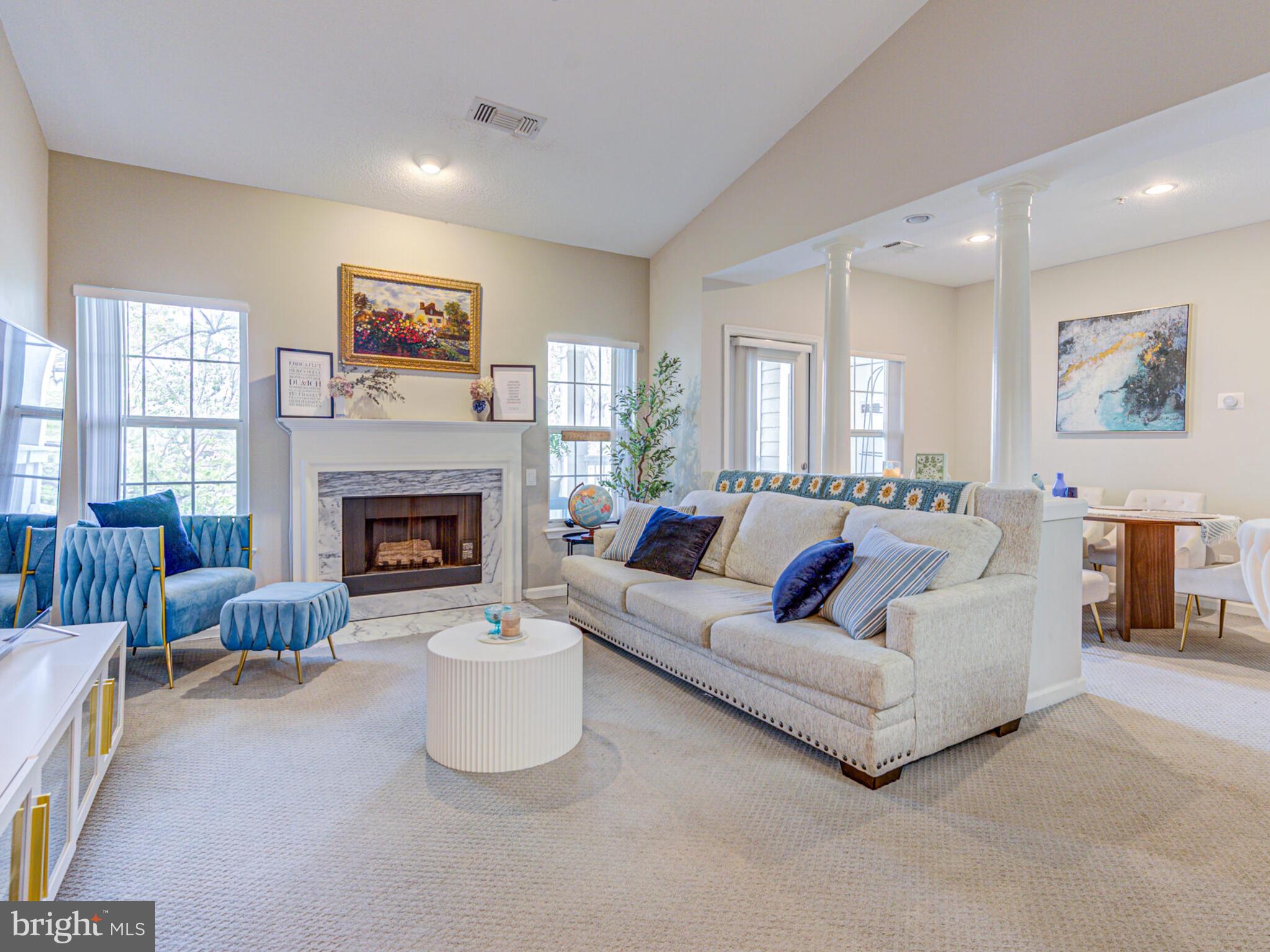 1720 Lake Shore Crest Drive, Unit 35 Reston, VA 20190 - Photo 5 of 41 a living room with furniture and a fireplace