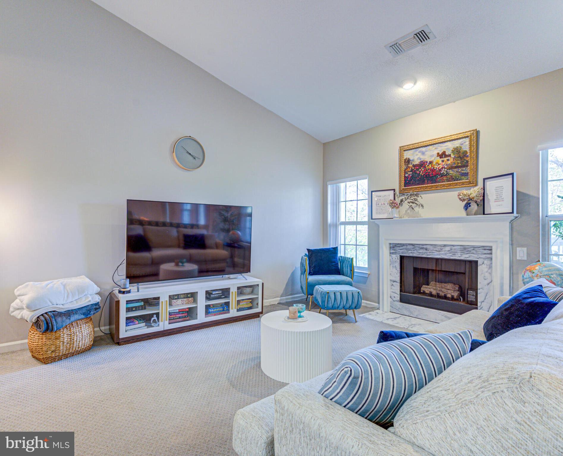 1720 Lake Shore Crest Drive, Unit 35 Reston, VA 20190 - Photo 6 of 41 a living room with furniture and a flat screen tv
