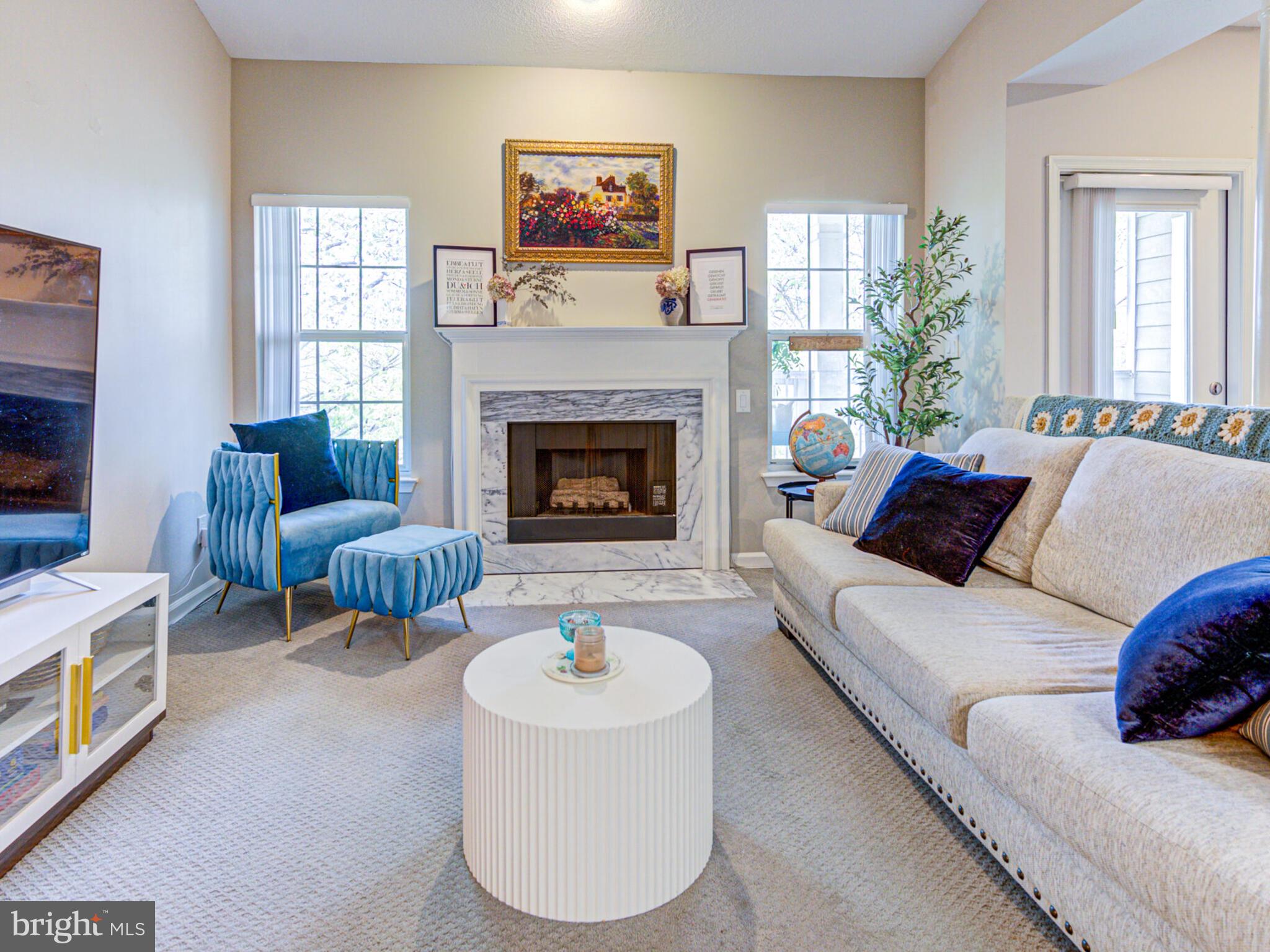 1720 Lake Shore Crest Drive, Unit 35 Reston, VA 20190 - Photo 7 of 41 a living room with furniture and a fireplace