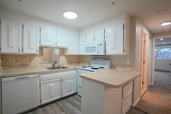 a kitchen with a sink a stove and cabinets