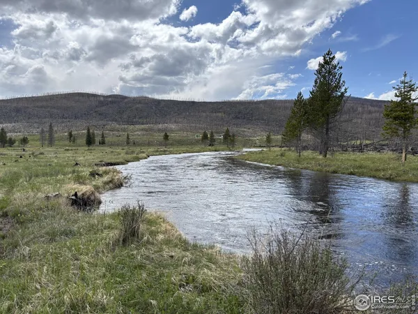 a view of a lake view with houses in background