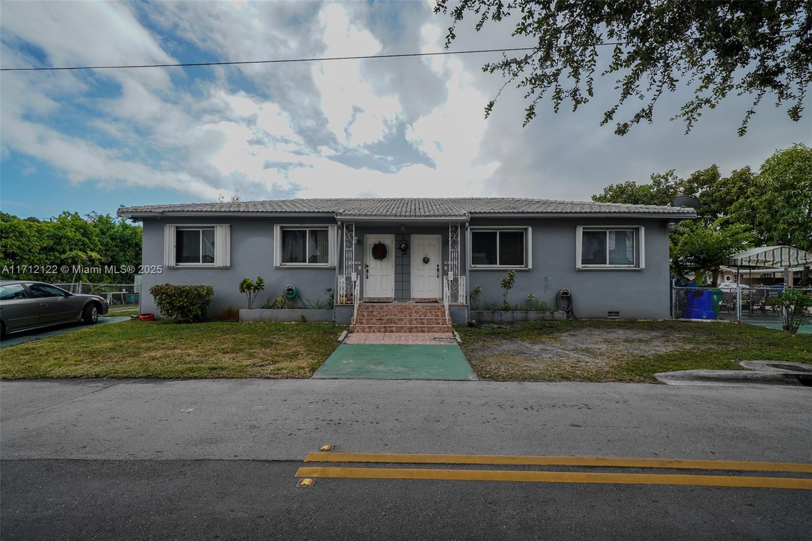 3140-42 Southwest 27th Terrace Miami, FL 33133 - Photo 1 of 3 a front view of house with garage and yard