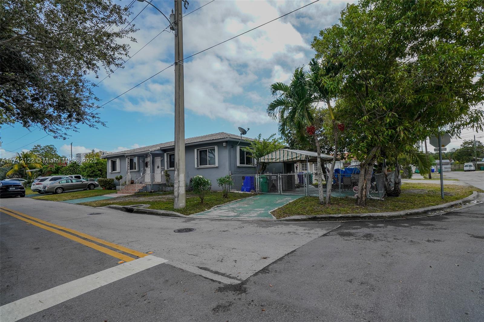 3140-42 Southwest 27th Terrace Miami, FL 33133 - Photo 2 of 3 a view of a house with a yard and large trees
