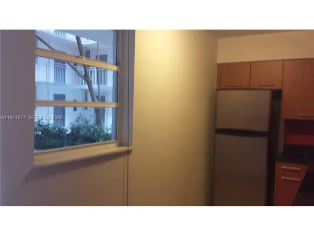 a kitchen with a refrigerator and a sink