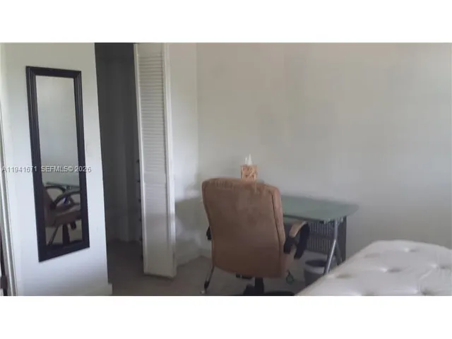 a black and white photo of a bedroom